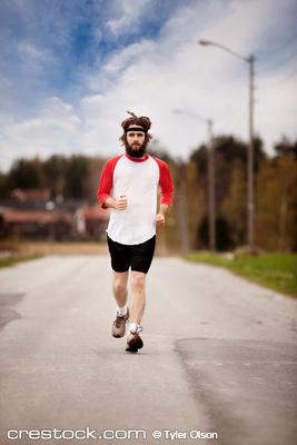 A tired retro style jogger running on a road o...